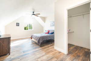 Bedroom featuring lofted ceiling, wood finished floors, and ceiling fan