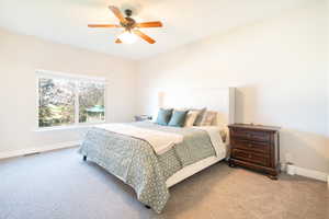 Bedroom featuring ceiling fan and light colored carpet