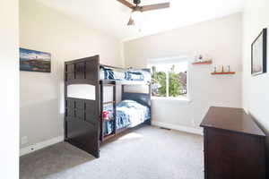 Bedroom with light colored carpet and ceiling fan