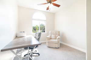 Home office with carpet floors and ceiling fan
