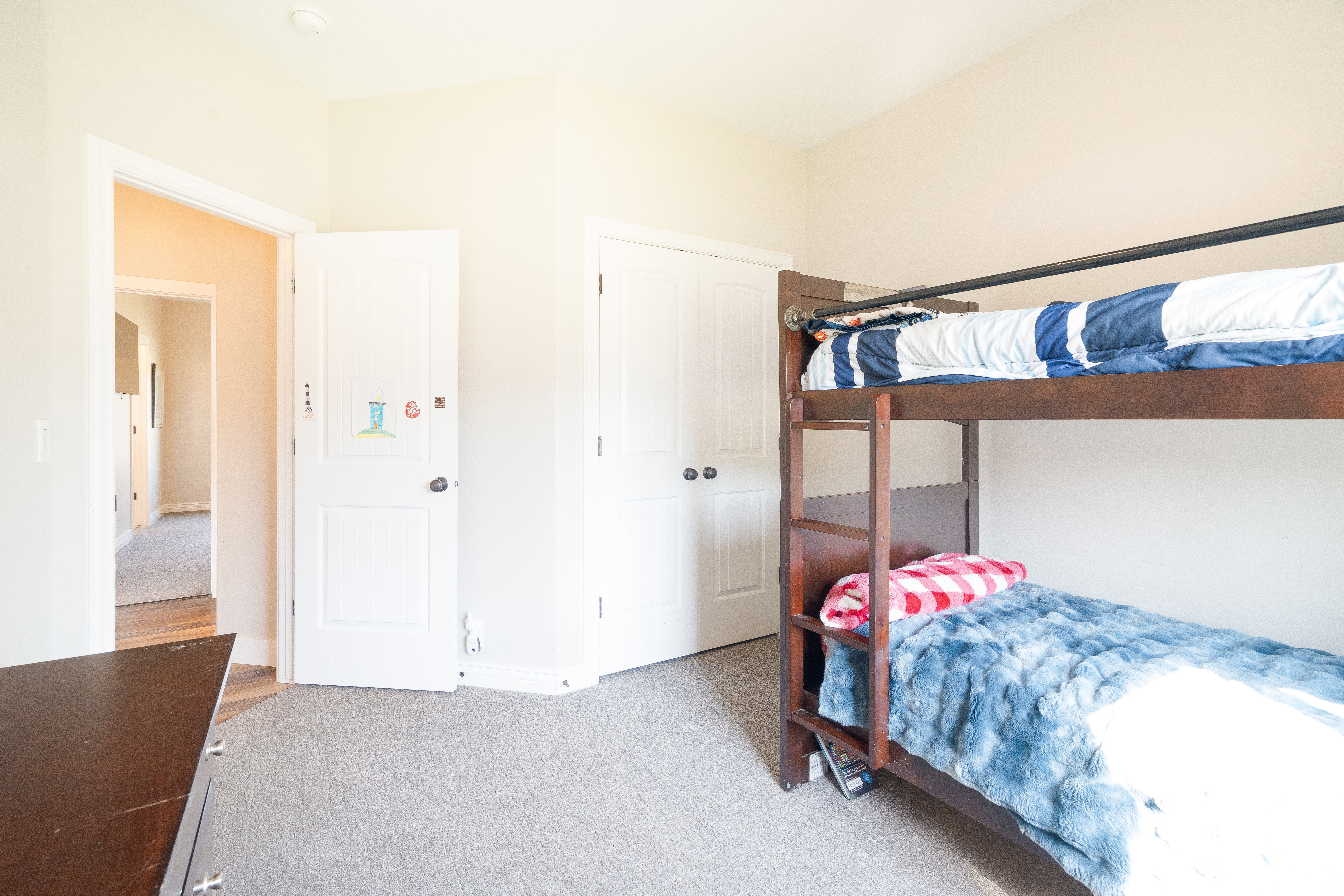 Bedroom featuring light carpet and a closet