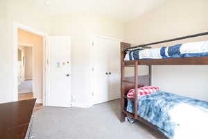 Bedroom featuring light carpet and a closet