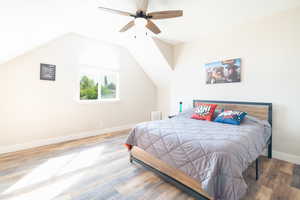Bedroom with wood finished floors and ceiling fan