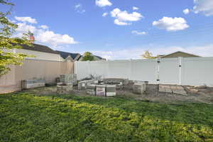 Fenced backyard with a gate and a vegetable garden