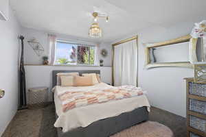Bedroom featuring carpet floors and hanging lights