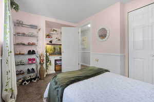 Carpeted bedroom featuring a closet