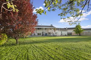 Back of property featuring stairs and a patio