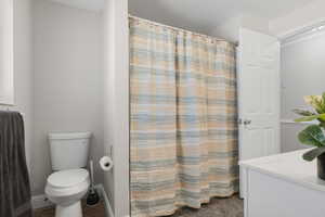 Bathroom featuring curtained shower and vanity