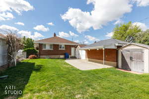 Back of property with a garden and storage shed