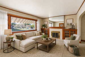 Virtually staged living area featuring arched walkways, a tiled fireplace, and ornamental molding