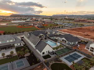Aerial view at dusk of a mountain view and view of pool