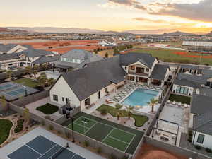 Aerial view of residential area with a pool and mountains