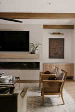 Living room with wood finished floors and beam ceiling