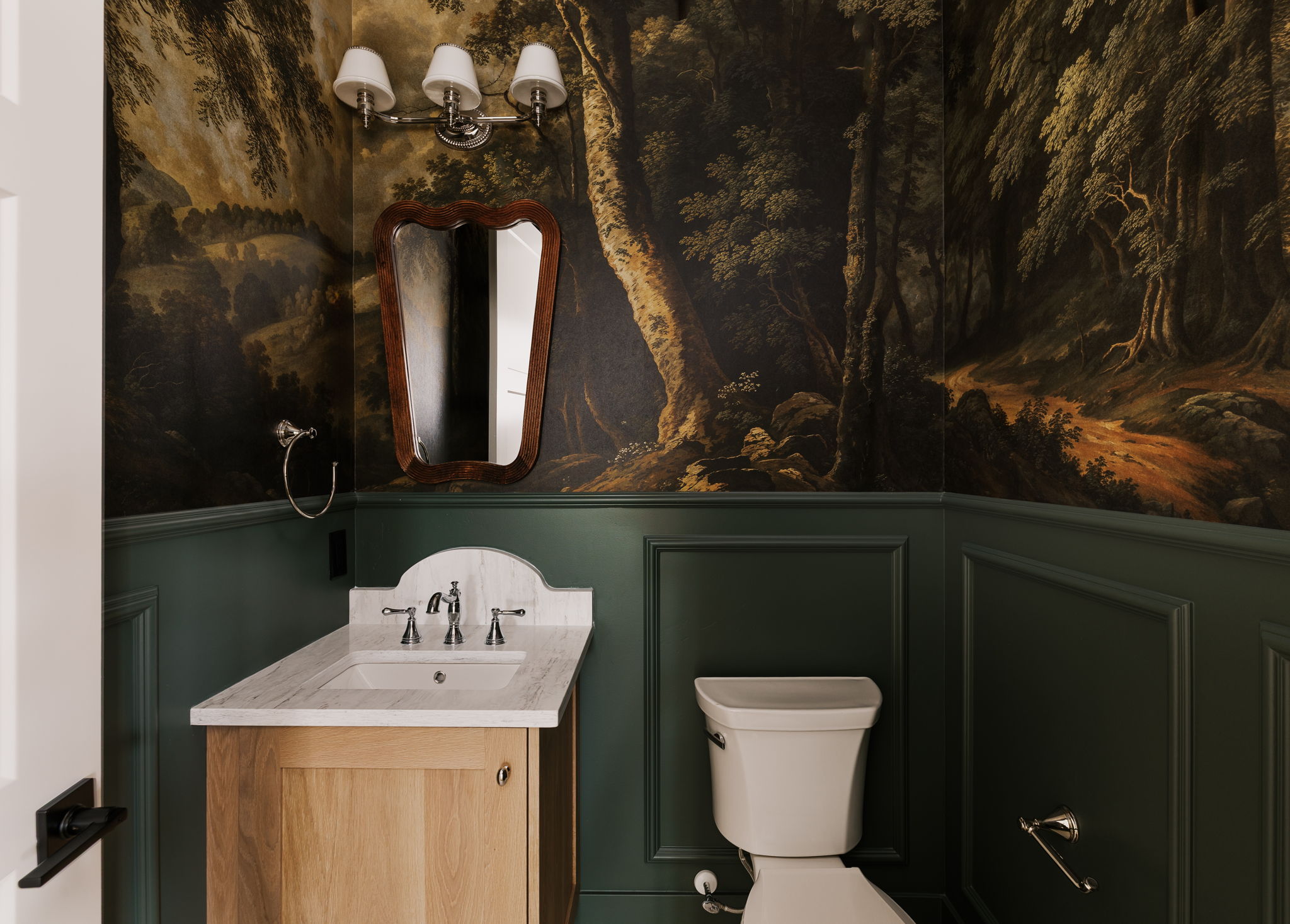 Powder Bathroom featuring vanity and a decorative wall