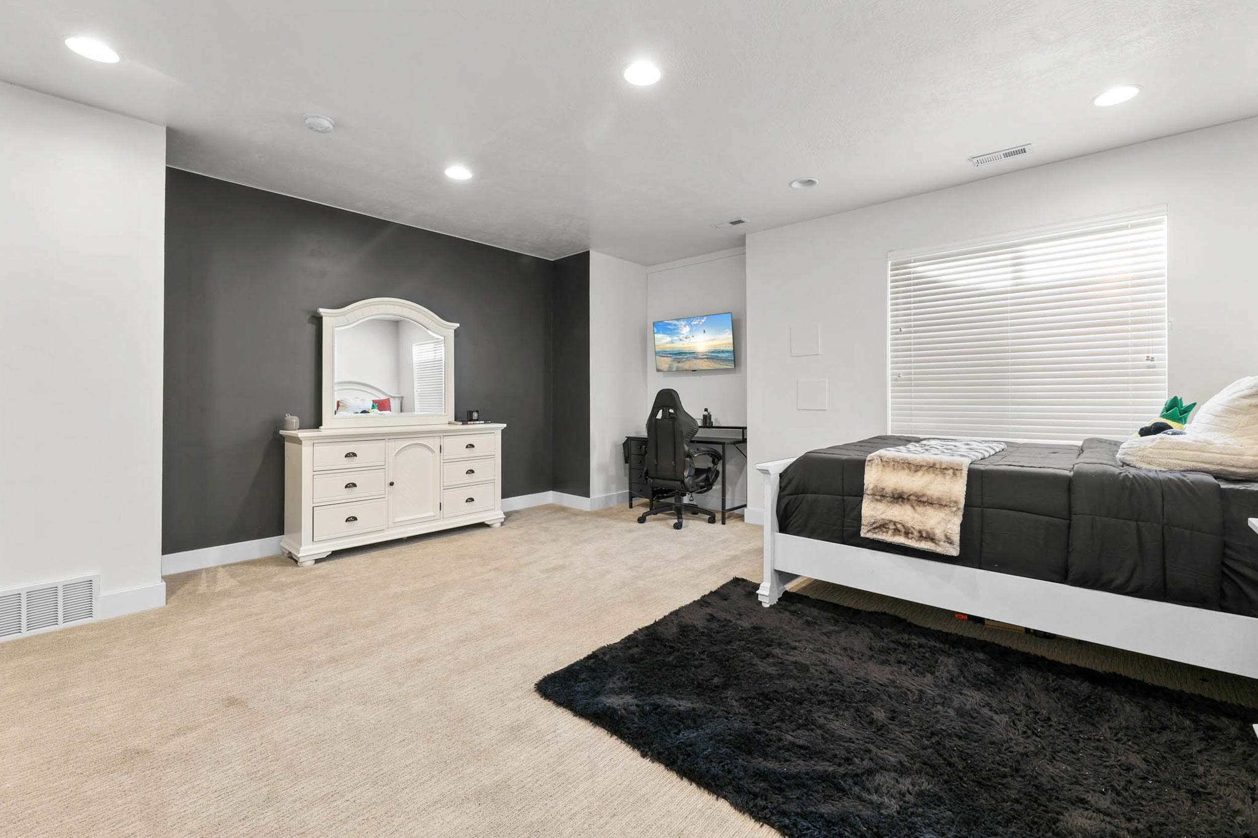 Bedroom featuring recessed lighting, light colored carpet, and an office area