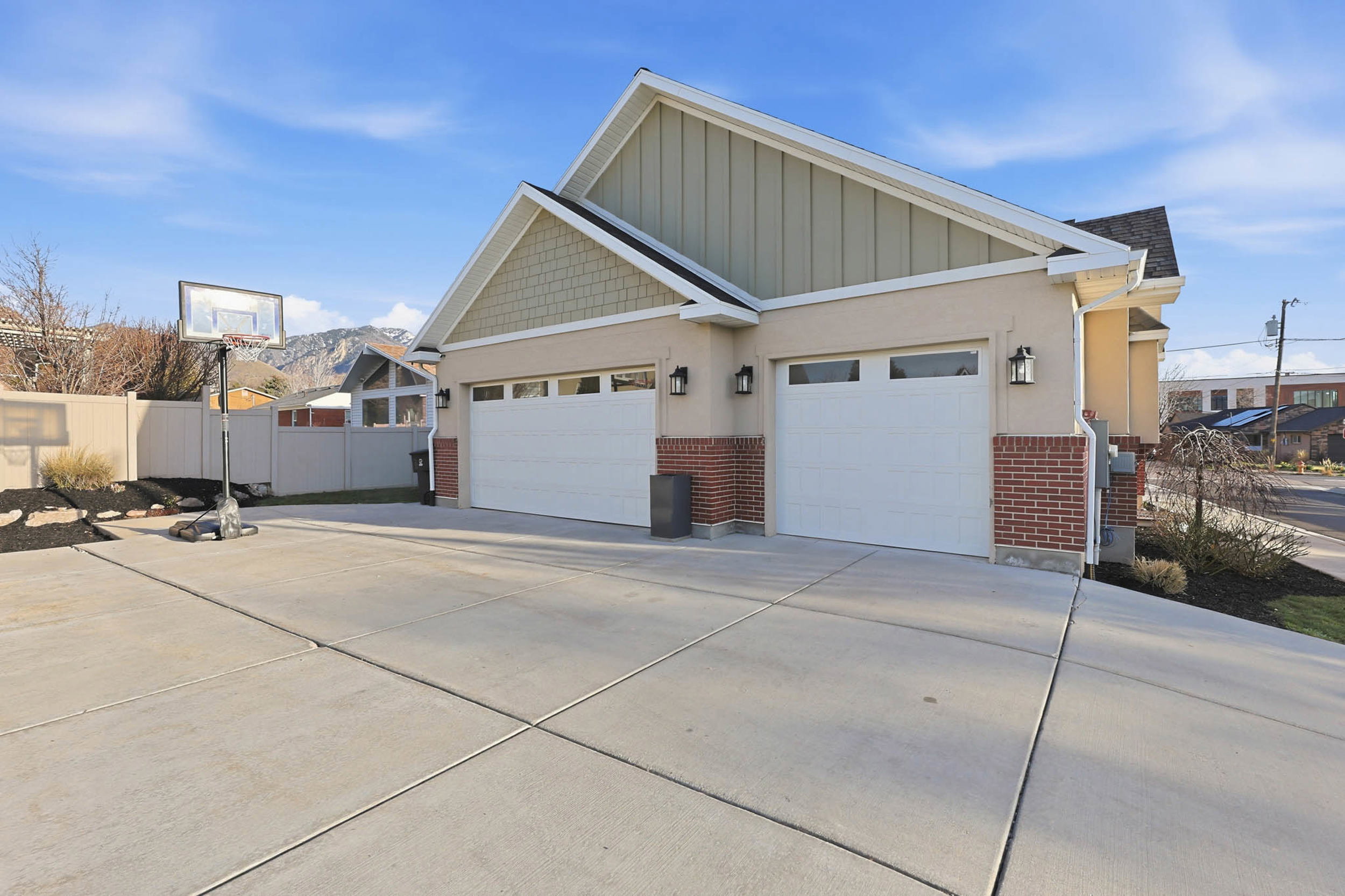 View of side of home featuring brick siding, concrete driveway, and a garage