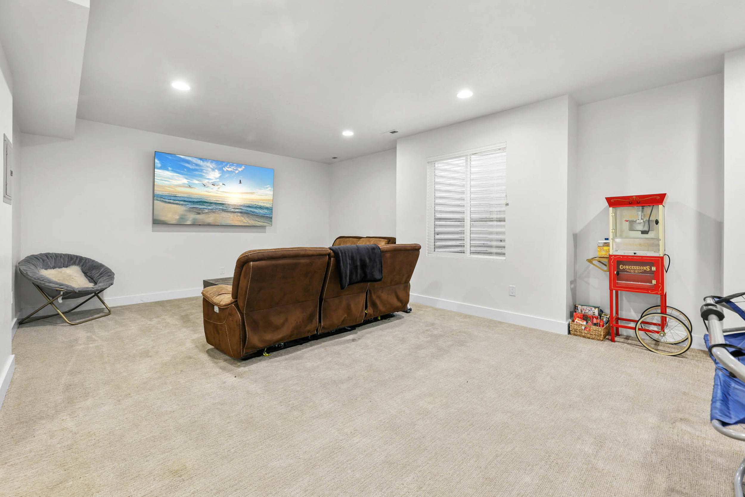 Sitting room with light carpet and recessed lighting