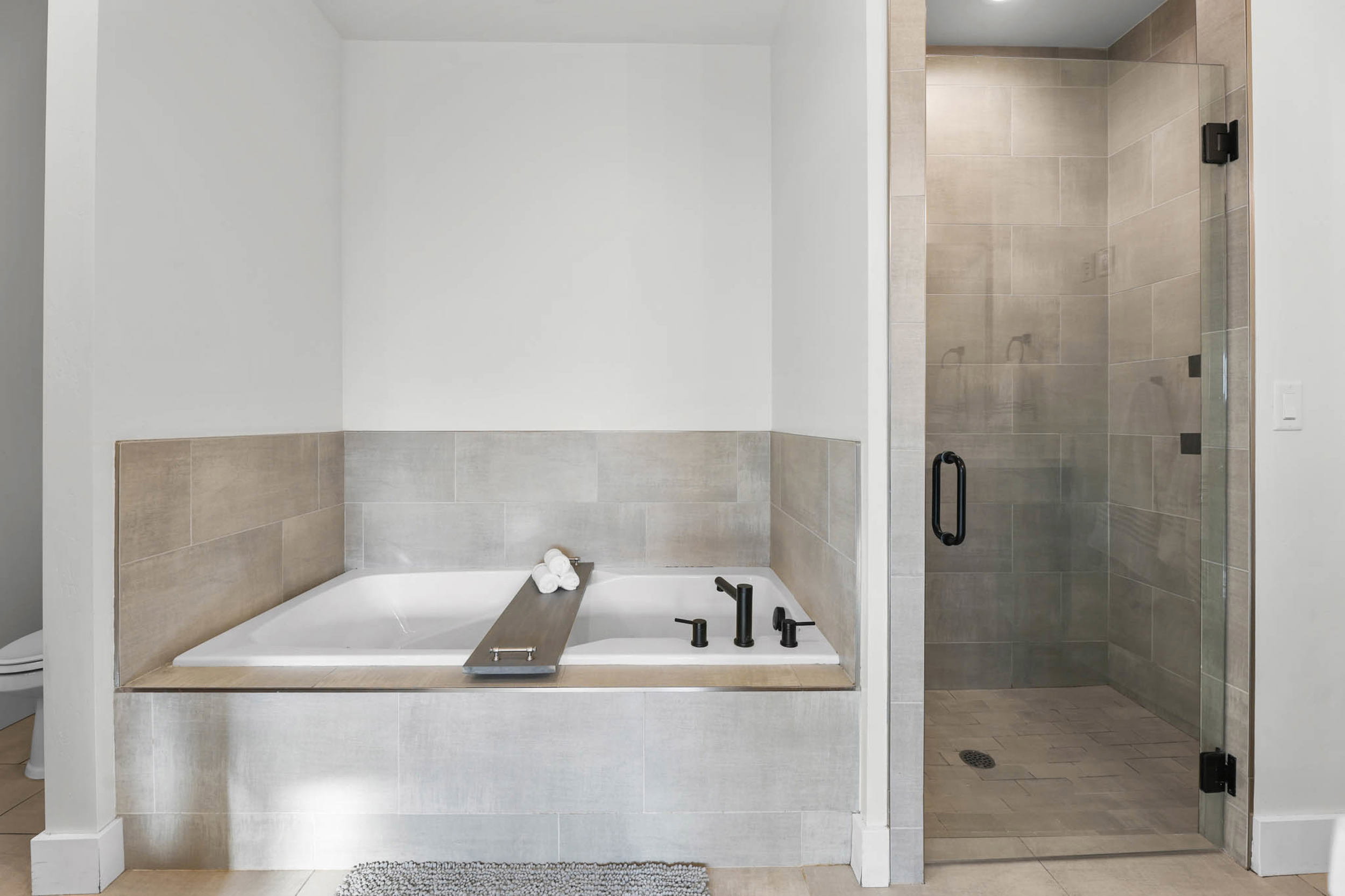 Full bathroom featuring a bath and a shower stall