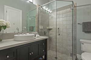 Bathroom featuring vanity and a stall shower