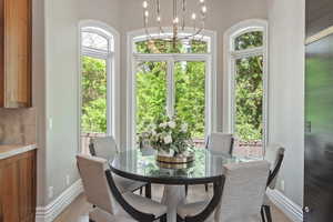 Dining nook featuring suspended lighting with tons of natural light