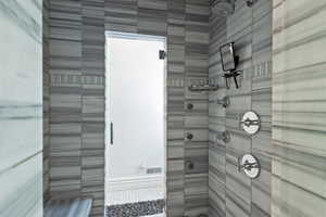 Spa inspired shower with multiple shower heads.