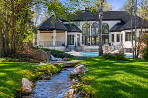 A private and secluded backyard to die for!  Streams, ponds, saline swimming pool, spa, basketball court, lighted outdoor kitchen, fire bowls and more.