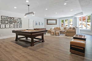 Recreation room featuring light wood finished floors, recessed lighting, and pool table - walkout to pool and backyard