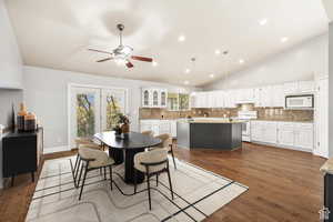 Dining space with dark wood-type flooring, recessed lighting, lofted ceiling, and a ceiling fan