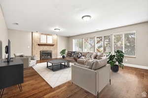 Living room with hardwood / wood-style flooring and a large fireplace