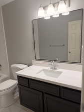 Full bath featuring vanity, shower / bathtub combination, and light marble finish flooring