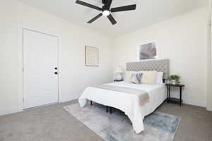Carpeted bedroom featuring baseboards and a ceiling fan