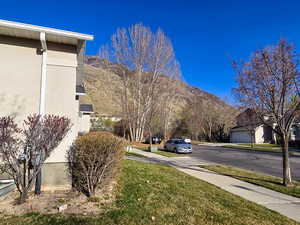 View of road featuring a mountain view, sidewalks, and a residential view