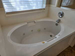 Bathroom featuring a tub with jets