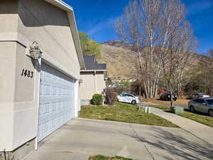 Garage with a mountain view and concrete driveway