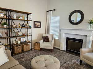 Sitting room featuring dark wood finished floors and a glass covered fireplace