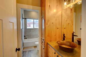 Bathroom featuring vanity, pocket door for privacy and  shower combination.