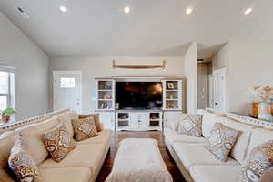 Living area with wood finished floors and recessed lighting