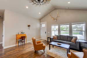 Living room with wood finished floors and recessed lighting