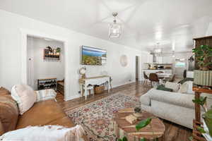 Living area featuring dark wood-style floors and baseboards