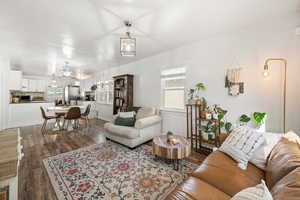 Living room with dark wood-type flooring and baseboards