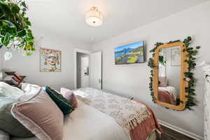 Bedroom with baseboards and wood finished floors