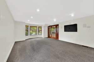 Carpeted spare room with recessed lighting and baseboards