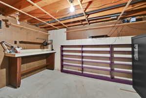 Unfinished below grade area featuring a workshop area