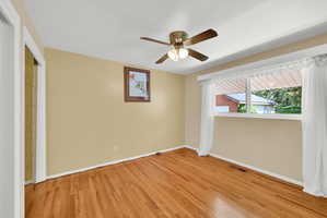 Unfurnished bedroom with light wood-style flooring, ceiling fan, and a closet