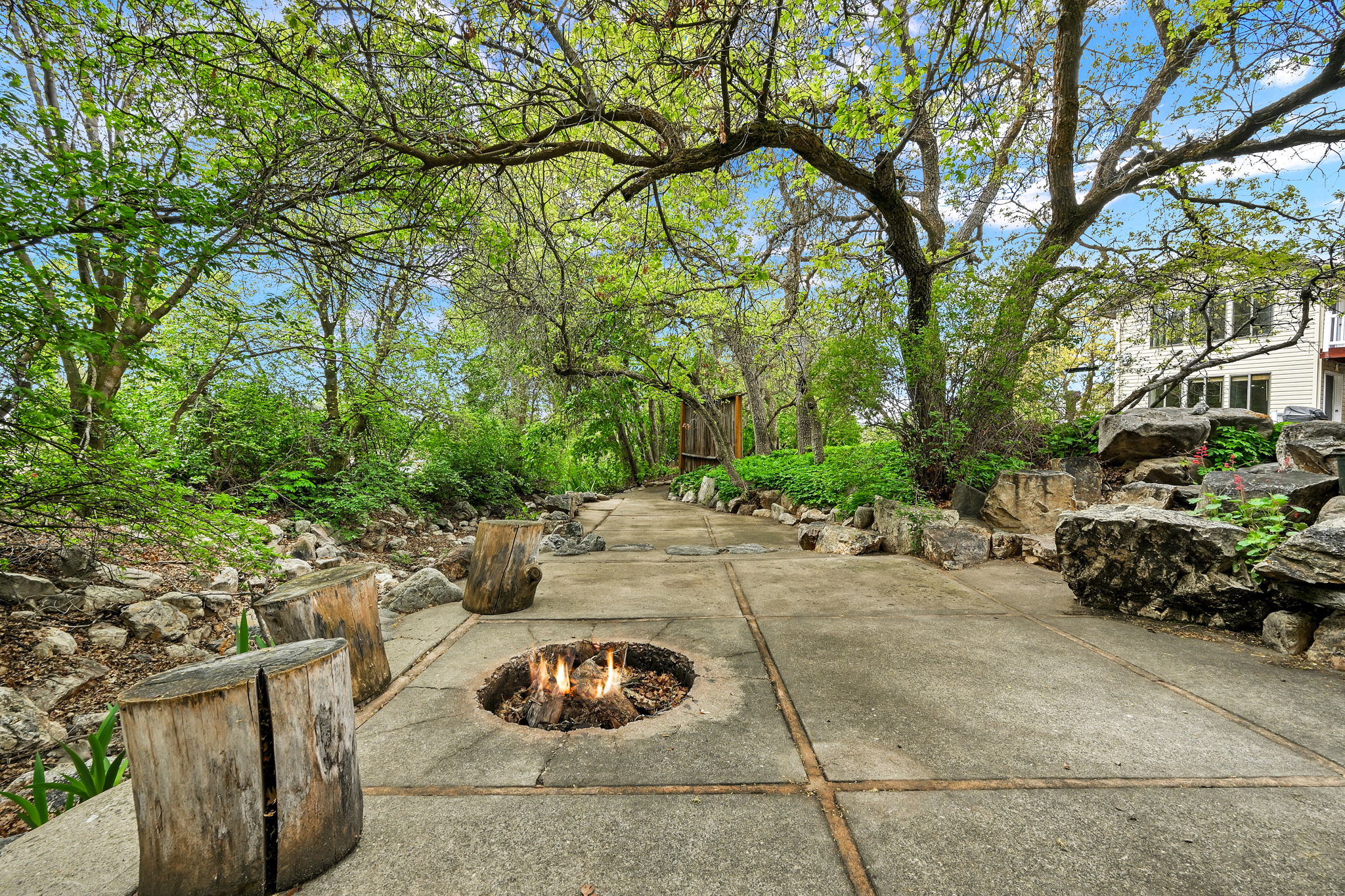 Downstream view of backyard patio / terrace with an outdoor fire pit