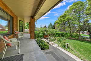 Covered porch with a yard