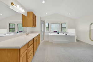 Full bathroom with a bath, a shower stall, vanity, light colored carpet, and recessed lighting