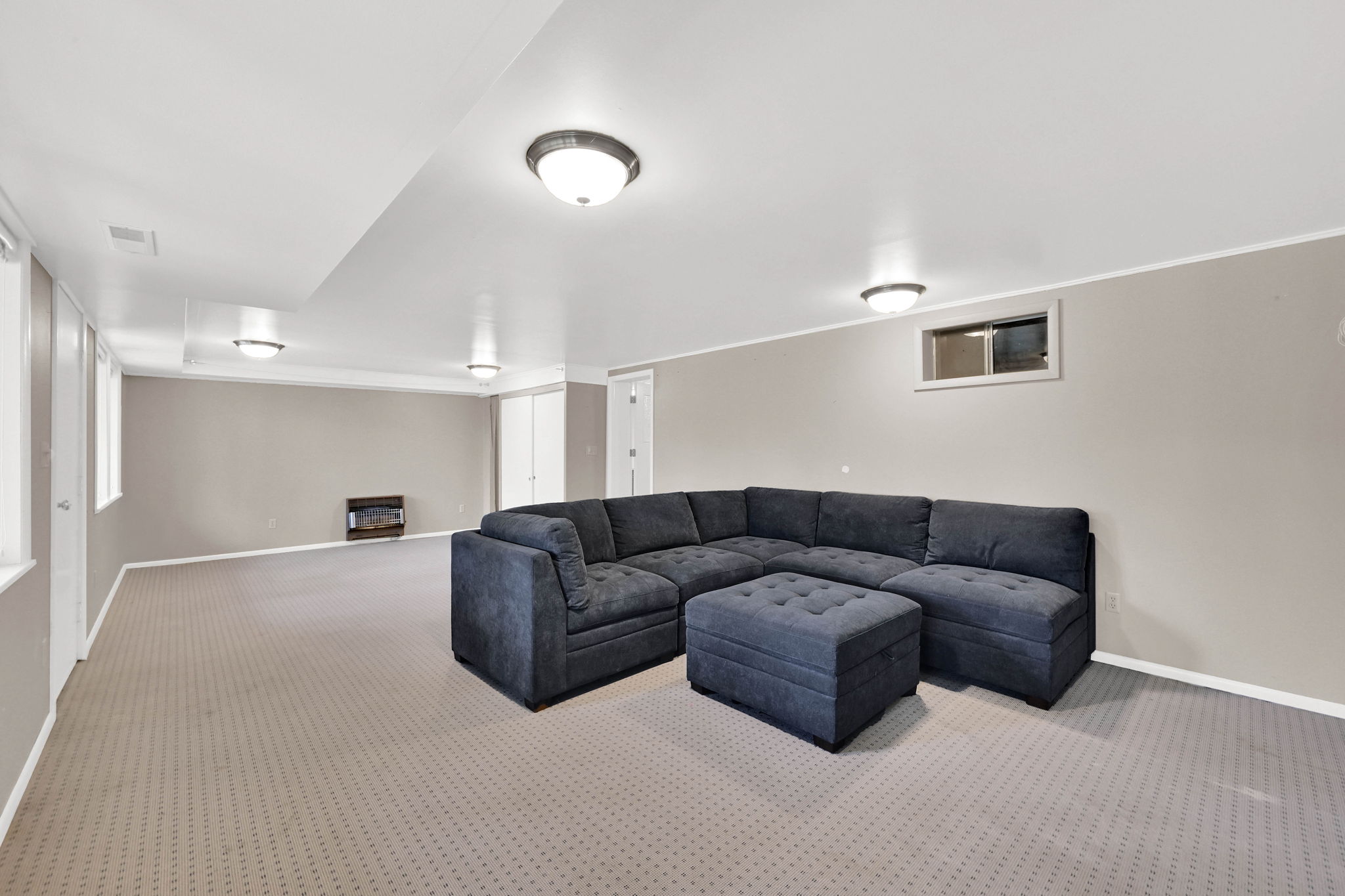 Carpeted living room featuring baseboards