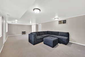 Carpeted living room featuring baseboards