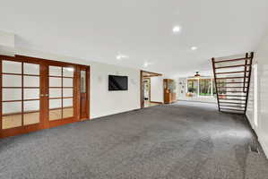 Unfurnished living room with carpet flooring, french doors, a ceiling fan, and recessed lighting